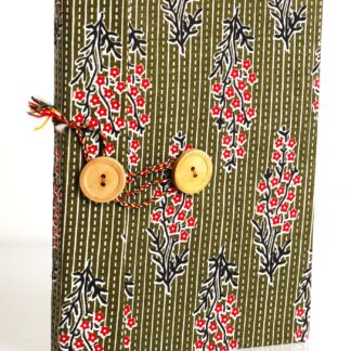 Handmade diary with floral pattern fabric overlapping cover and wooden button closure